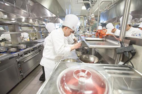 Student working in culinary kitchen