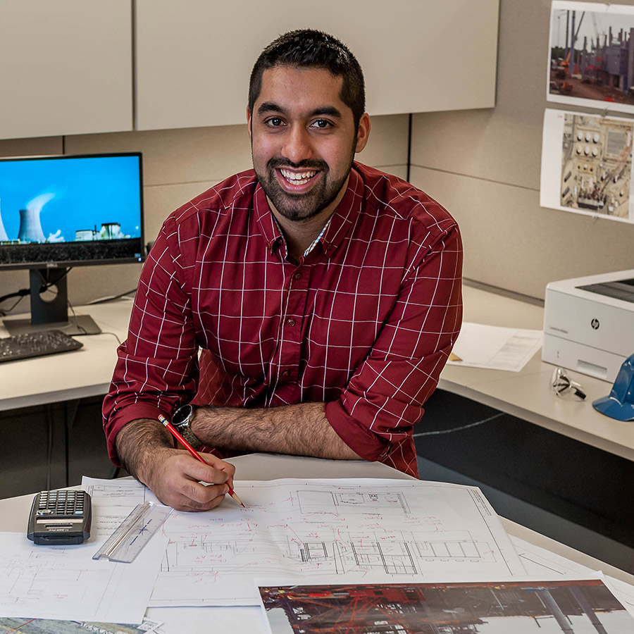 Azeam Anjum working at a desk