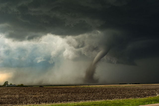 Photo of tornado going across a field