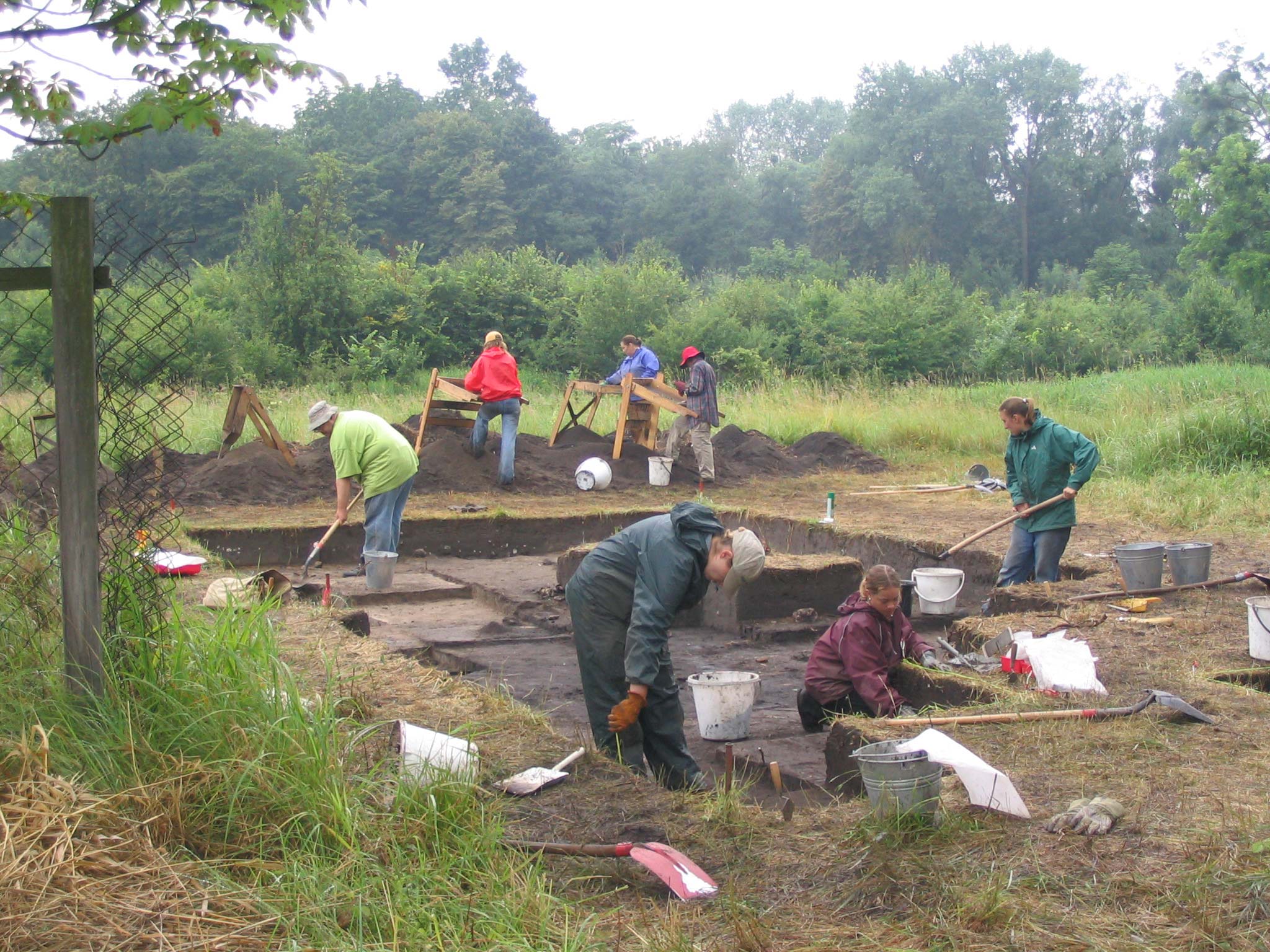 students digging in the mud