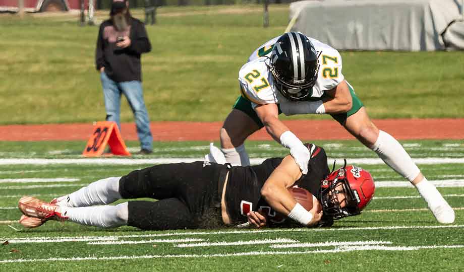 two football players fighting over the ball