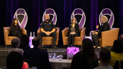 four members of a panel discussion stated on stage