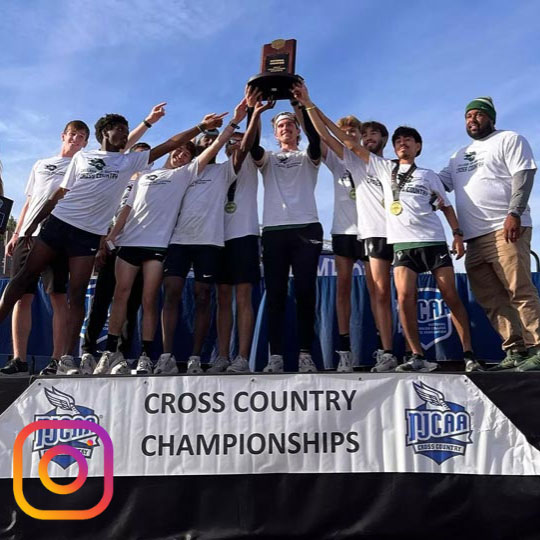 cross country team with their award