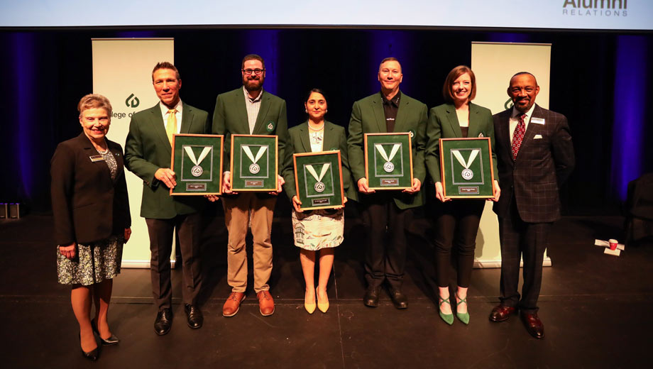 Awarded distinguished alumni pose with their awards