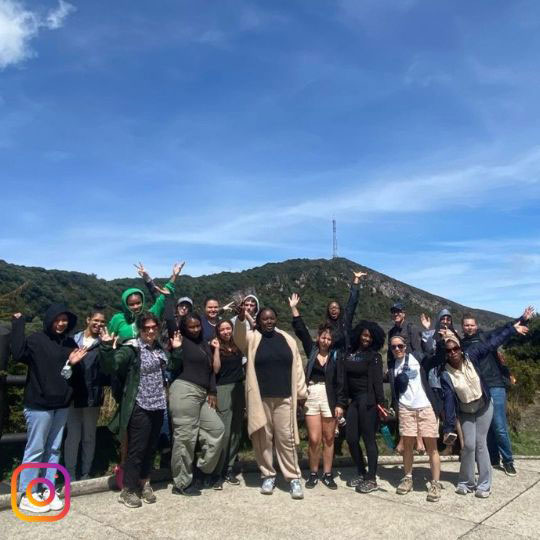 a group of students standing in front of a mountain in Costa Rica