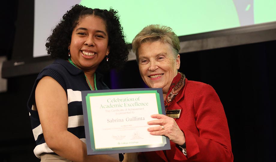 Sabrina Guillinta receives congratulations from Interim President Dr. Christine M. Hammond