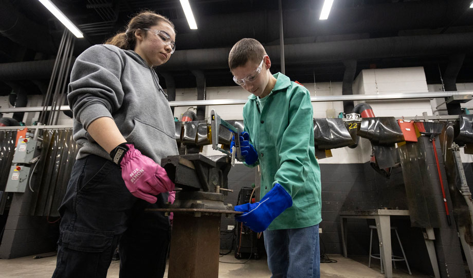 two Boy Scouts welding