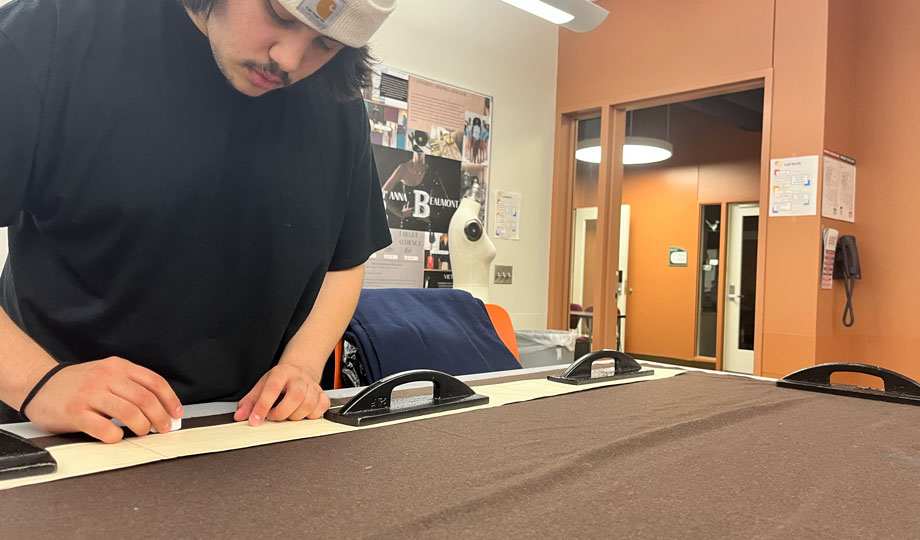 Student working with fabric in studio.