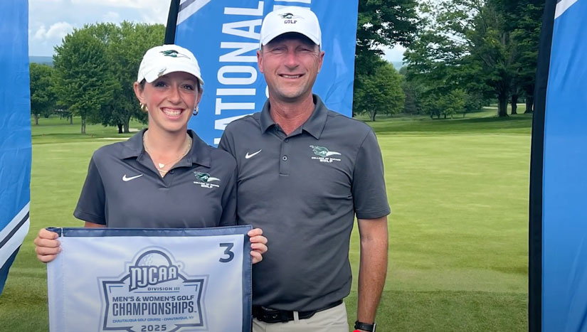 Modal Image Opens to lightbox video -Aubreye and Jason Hyatt holding a NCJAA championship flag