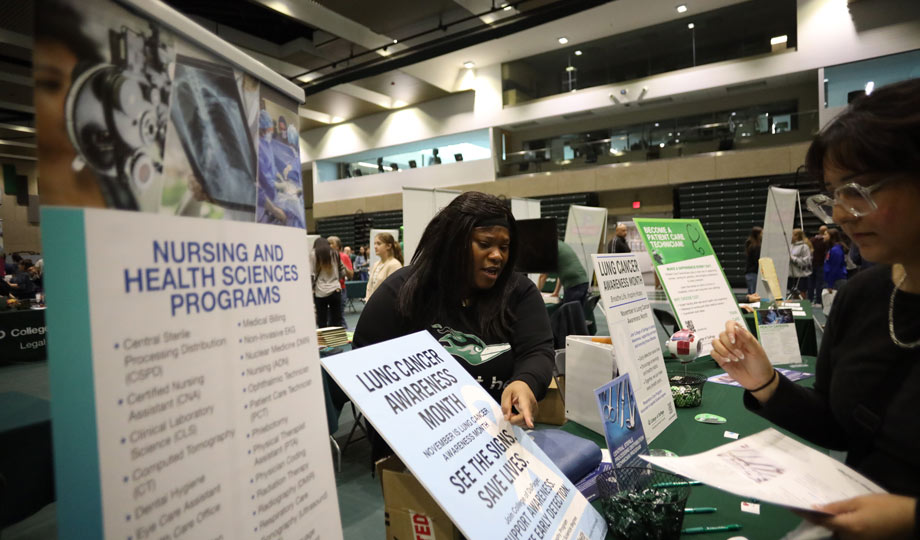 Program coordinator speaking with student.