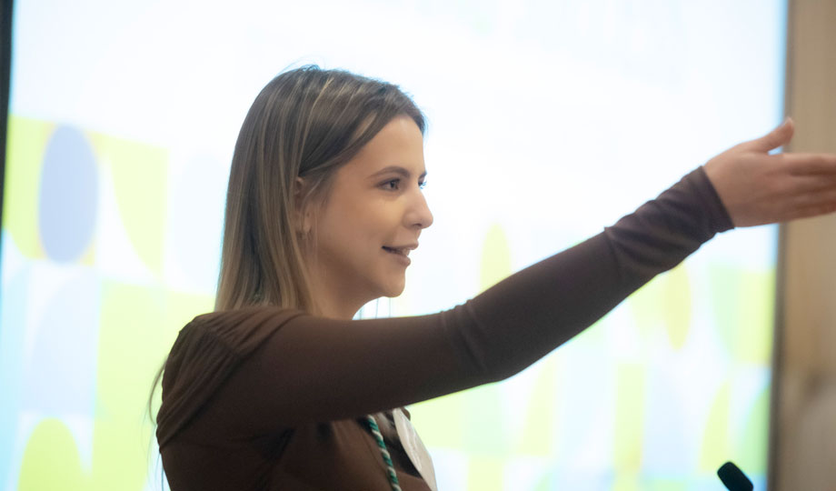 Woman speaking with outstretched arm.