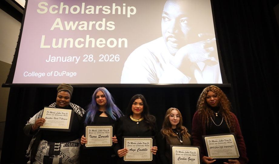 five students stand holding a certificate