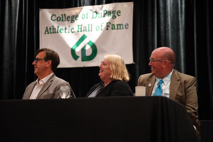 Athletic directors looking on at Athletics Hall of Fame ceremony.
