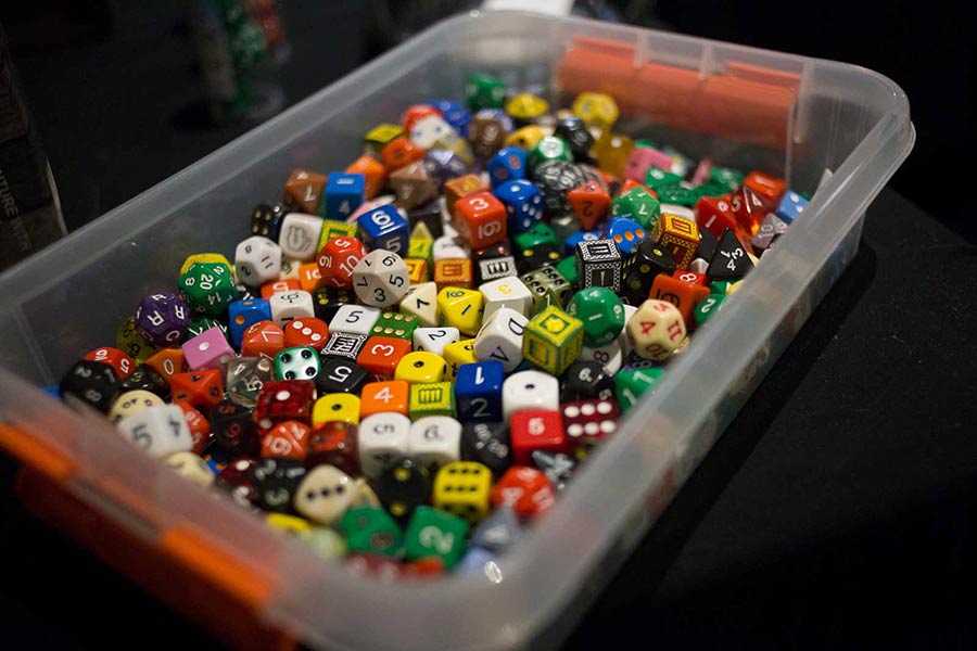 colored gaming dice in a bin