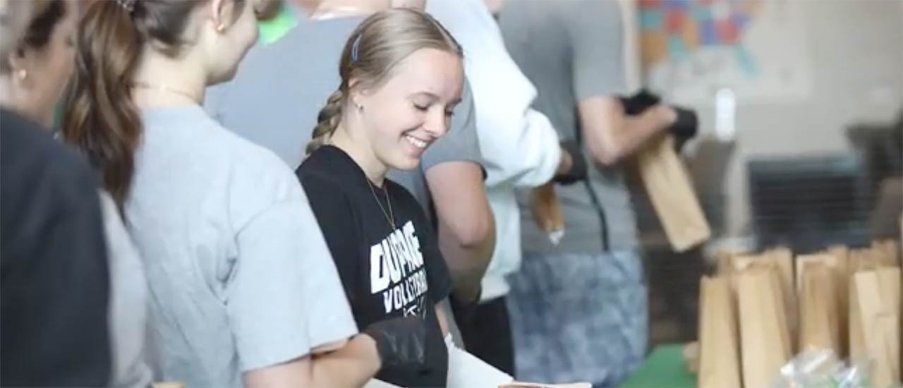 female student bagging a sandwich for lunch