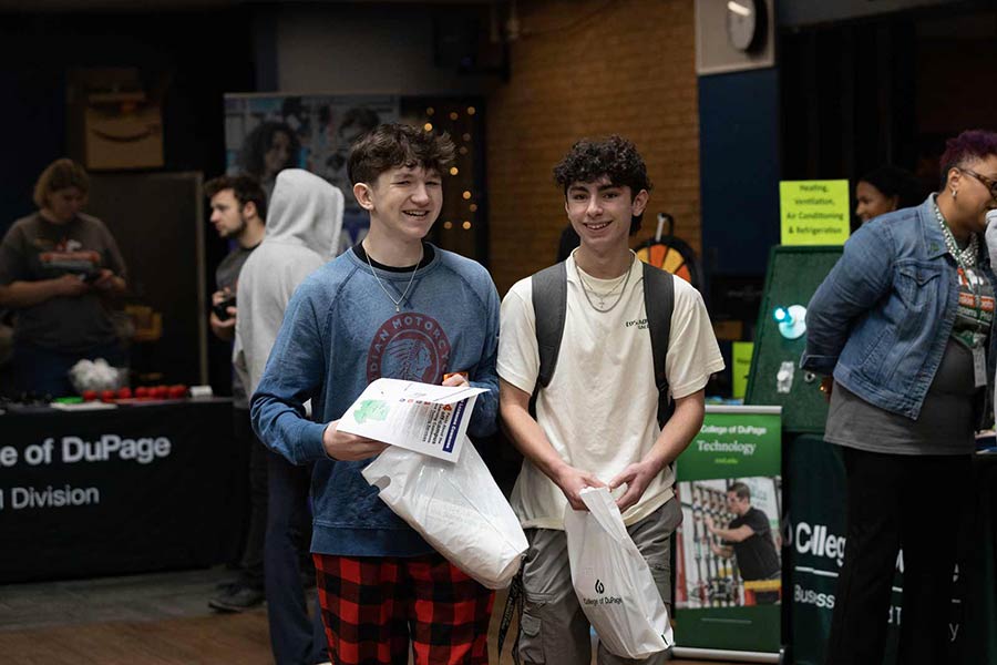 Two high schooler boys smiling at camera.