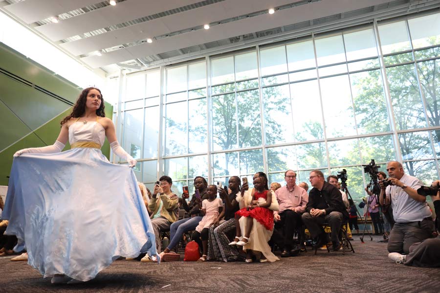 Model posing on catwalk in SSC atrium.