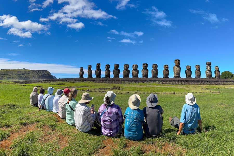 Travelers sitting on Easter Island.