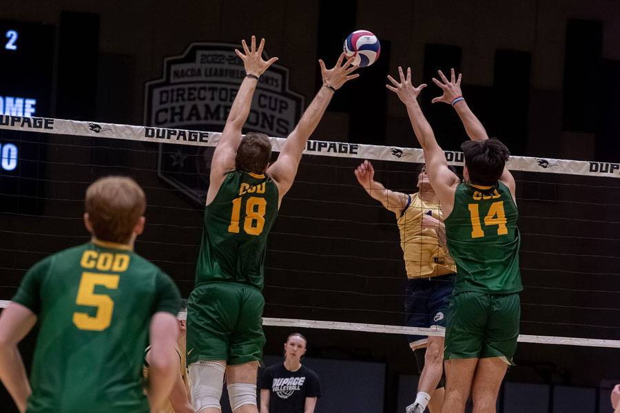 Men's Volleyball players on defense.