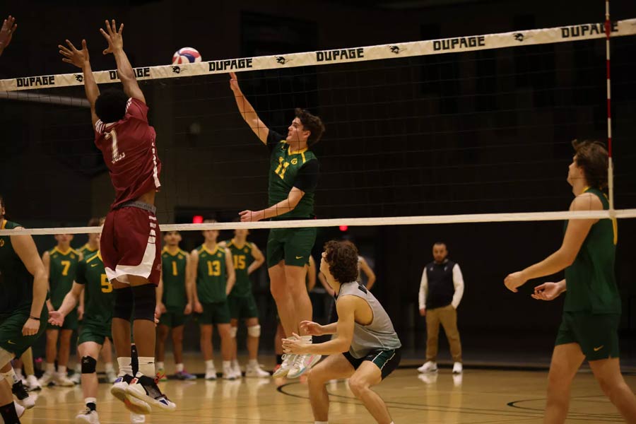 Volleyball player spiking ball over net