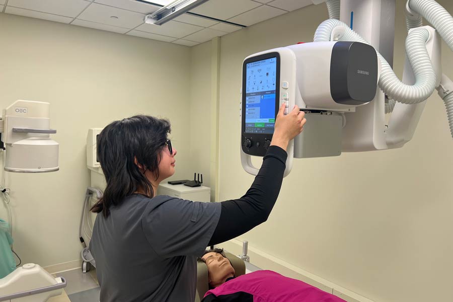 Student performing X-ray scan